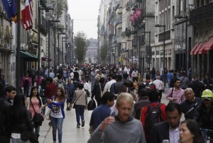 People walk along one of the main streets in downtown Mexico City